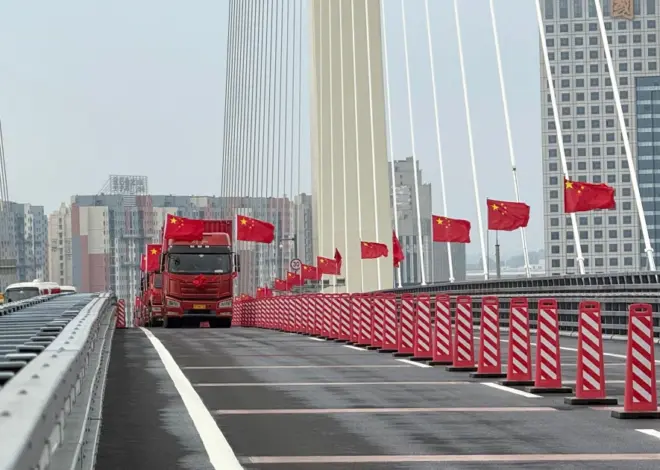 Trucks line up as long-delayed China-North Korea bridge officially opens
