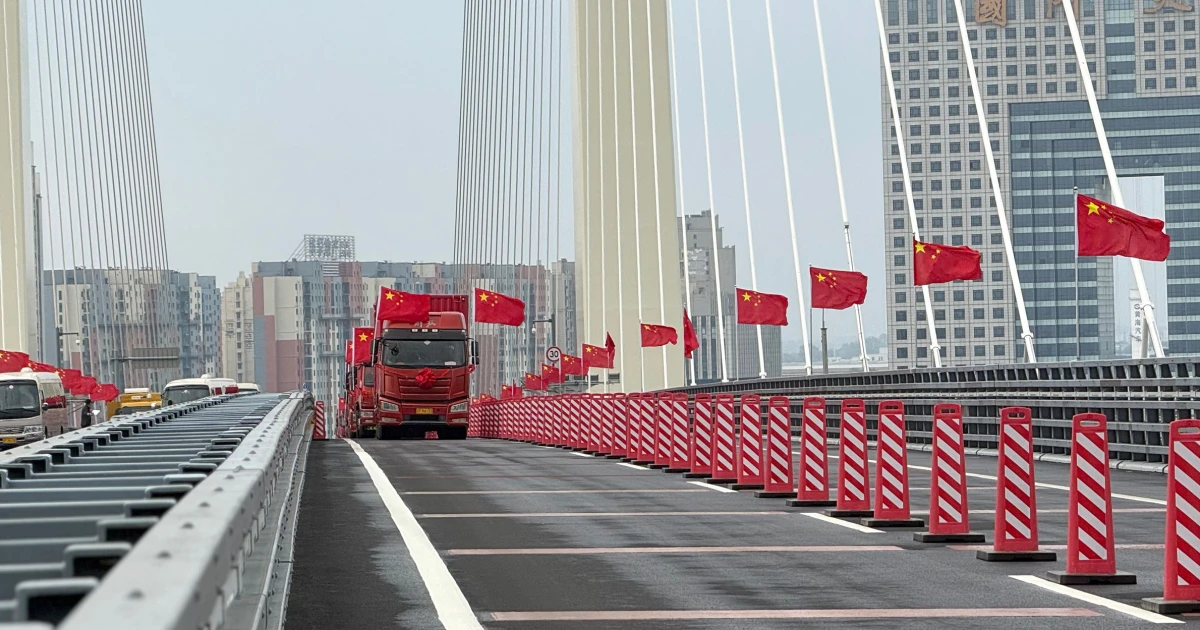 Trucks line up as long-delayed China-North Korea bridge officially opens